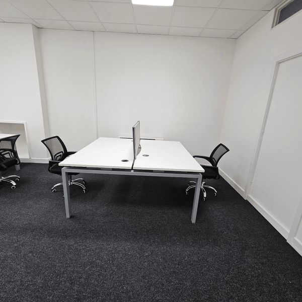 A serviced office in Unit 114 at 109 Portland St., Manchester, equipped with five desks for use.
