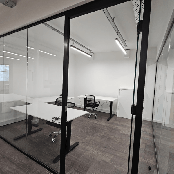 Serviced office with three desks, designed for focus, featuring a kitchen, meditation room, and a relaxing common area.