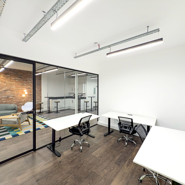 Bright and modern serviced office space for rent, featuring 3 ergonomic chairs, standing desks, and high ceiling.