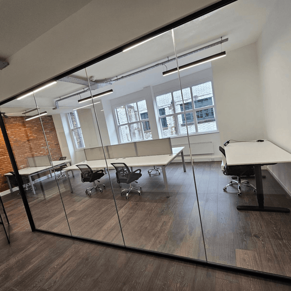 Bright and stylish 7-desk office in Manchester with high ceilings, large windows, kitchen, and a meditation room for relaxation.