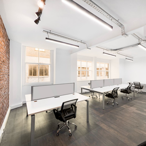 Bright serviced office space for rent with 7 ergonomic chairs, electric desks, power stations, and high ceilings.