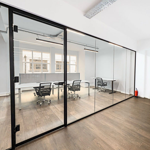 Spacious serviced office for rent featuring 7 ergonomic chairs, standing desks, large windows, and modern equipment.