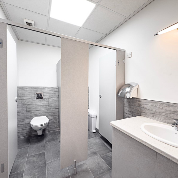 A clean, bright bathroom in a serviced office featuring modern fixtures and ample natural light.