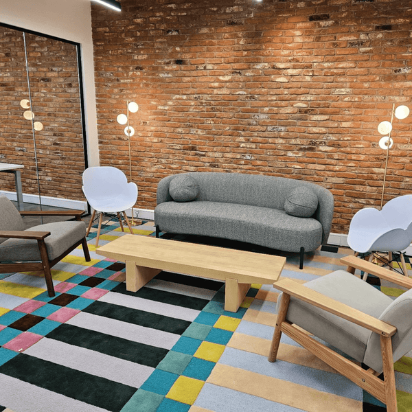 A break room of serviced offices in Portland Plaza, Manchester, featuring a couch, chair, and table arranged for relaxation and collaboration.