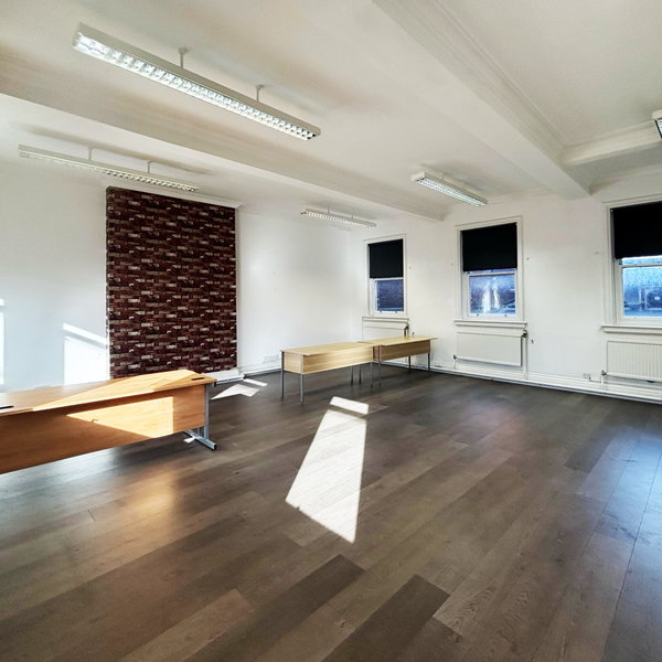 Serviced office space for rent in Bolton, Greater Manchester, featuring a modern layout with desks with built in power supply and large windows for natural light.
