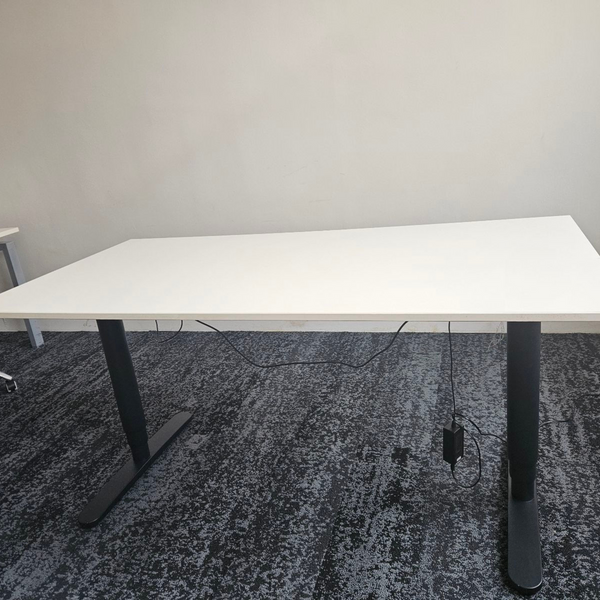 An electric stand-up desk, highlighting its ergonomic design and adjustable height functionality.