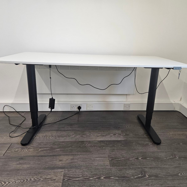 An electric stand-up desk in a modern office, showcasing adjustable height features for an ergonomic workspace.