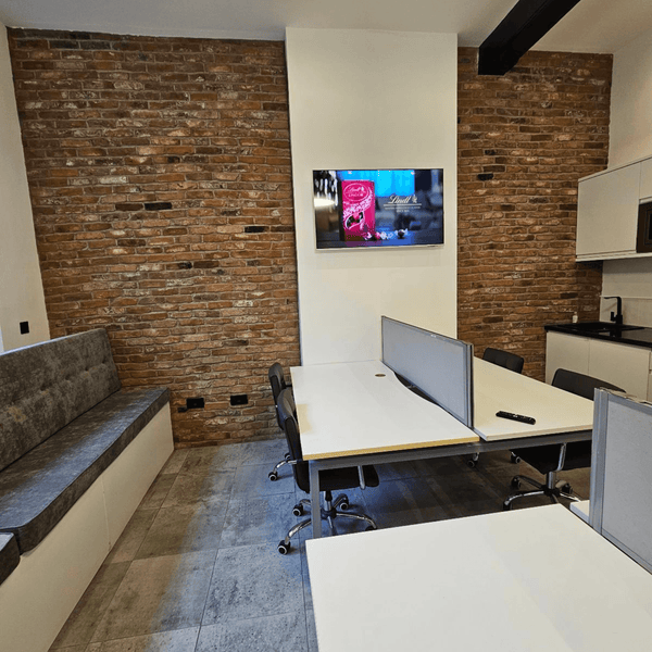 For Rent: Unit G1, a bright serviced office with 5 desks, high ceilings, and modern amenities on Portland Street, Manchester.