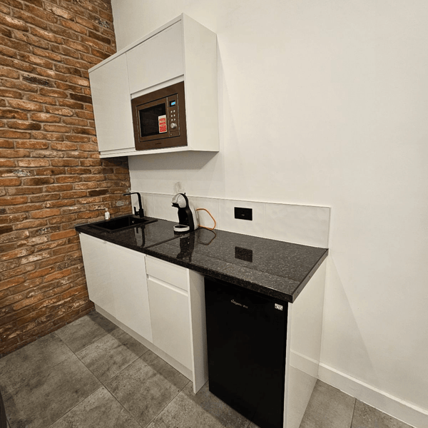 For Rent: Unit G1, a bright serviced office with 5 desks, and a fully equipped kitchen on Portland Street, Manchester.