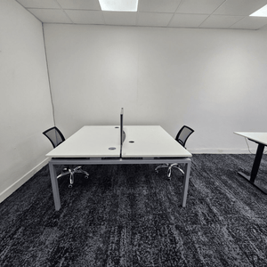 Method Spaces Office Unit 1A-101 offers five desks, high ceilings, natural light from large windows, renovated bathrooms, and street view of Portland, Manchester.