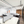 Spacious office for rent with 16 ergonomic chairs, plug-and-play desks, high ceilings, and ample natural light from large windows.