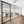 Spacious serviced office for rent featuring 7 ergonomic chairs, standing desks, large windows, and modern equipment.