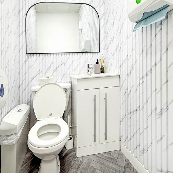 A well-lit, tidy bathroom in a serviced office, showcasing contemporary design and cleanliness.