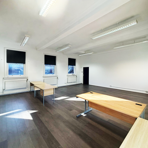 Serviced office space for rent in Bolton, Greater Manchester, featuring a modern layout with desks and large windows for natural light.
