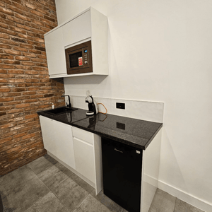 For Rent: Unit G1, a bright serviced office with 5 desks, and a fully equipped kitchen on Portland Street, Manchester.